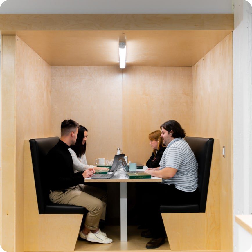 Employees in a meeting booth