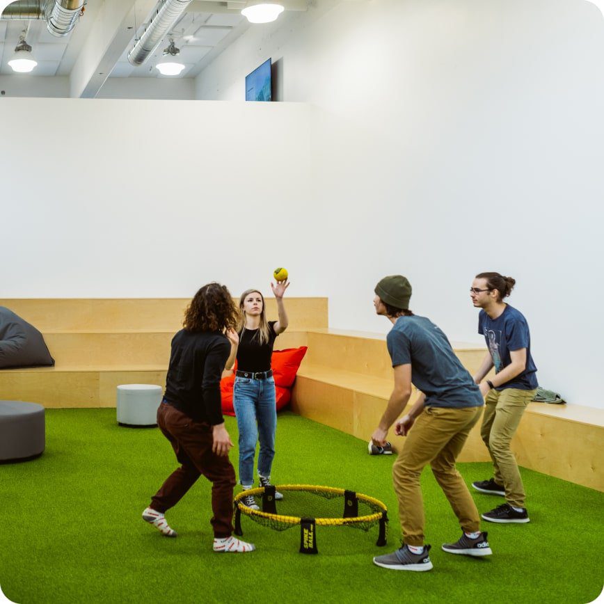 Employees playing Spikeball