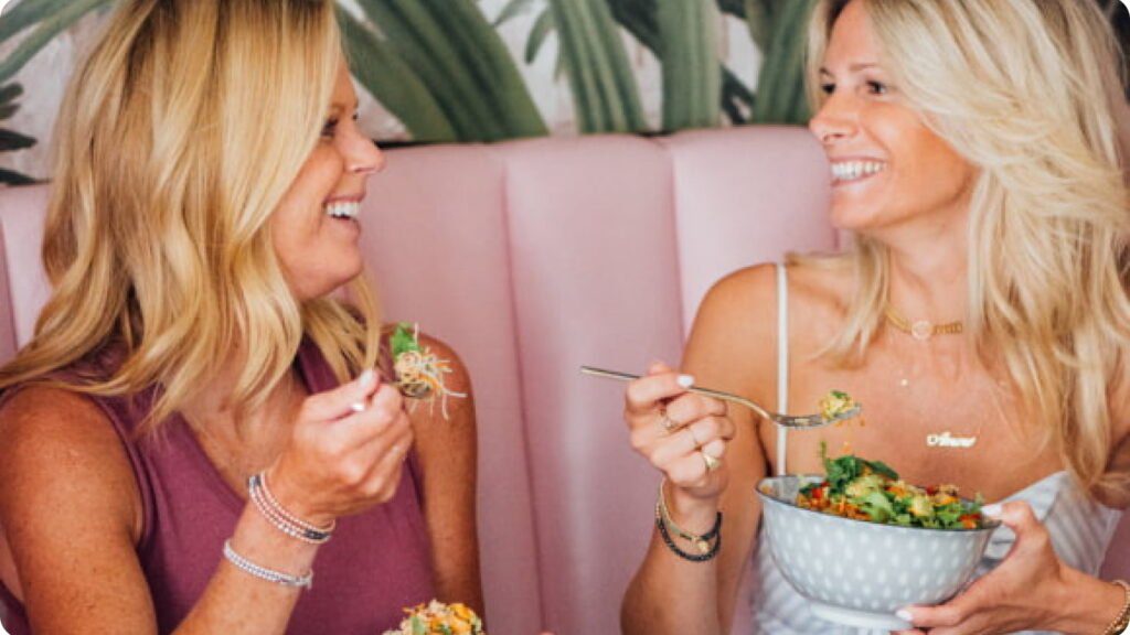 Two women laughing at lunch